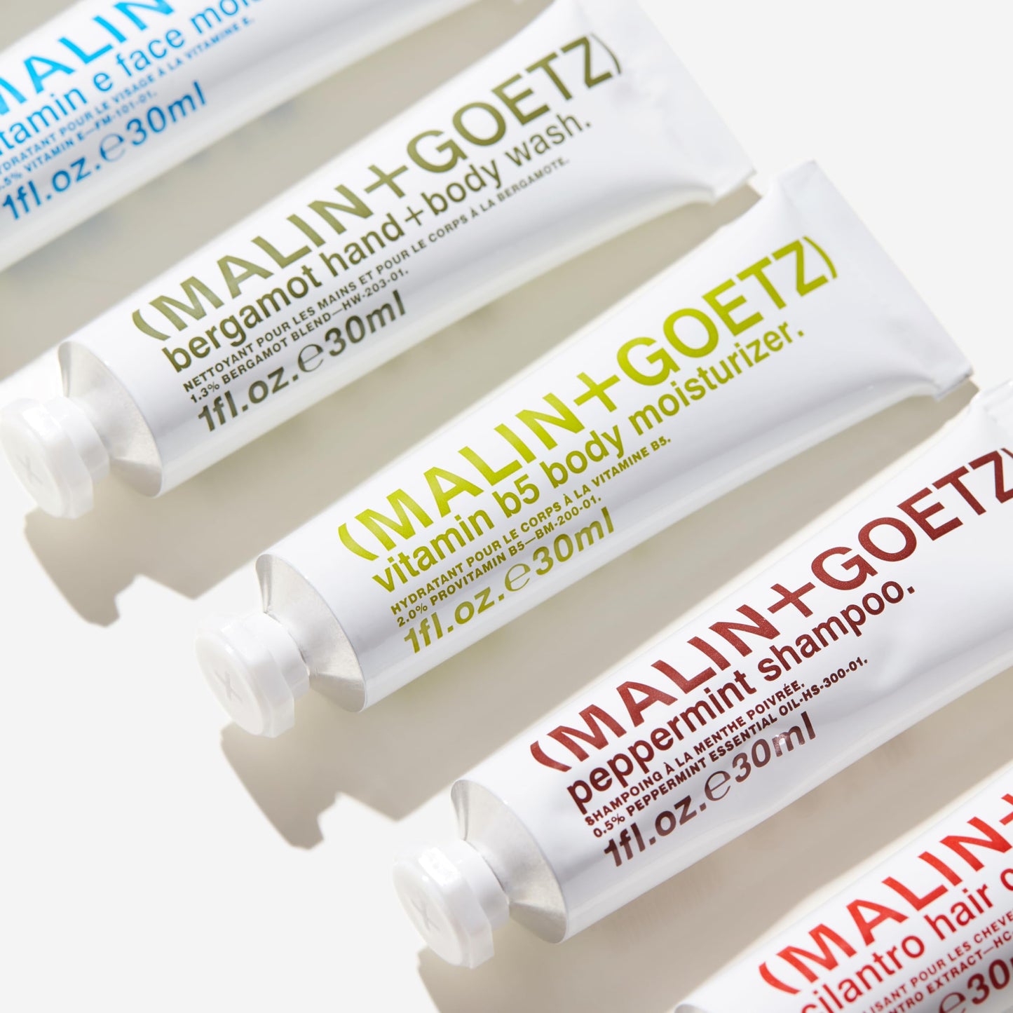 MALIN+GOETZ Best-Sellers Travel Kit | Six Everyday Essentials for Face, Body + Hair | Grapefruit Face Cleanser, Vitamin E Face Moisturizer, Peppermint Shampoo + More | Vegan, Travel-Friendly(6 x 1 oz)